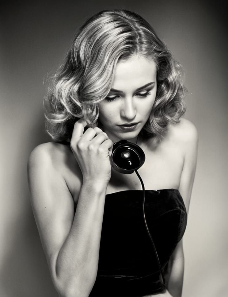 a gorgeous woman with an angelic voice saying: call me when you are lonely on a vintage phone; noir; vintage; 