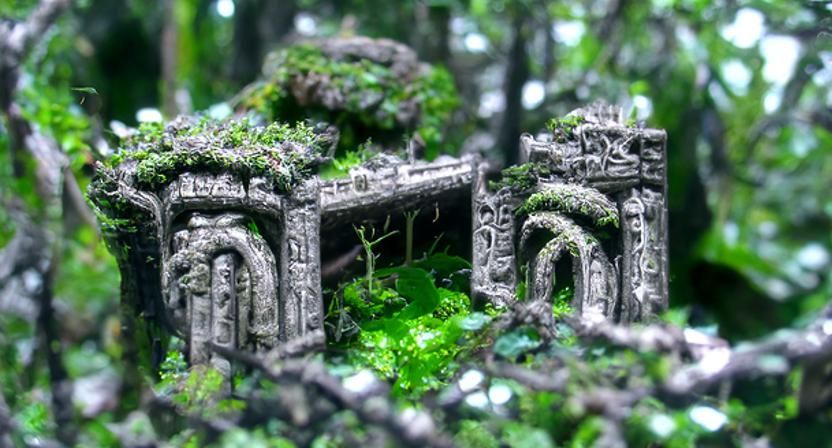 Ancient temple ruin in a forest with moss and vines, detaile...