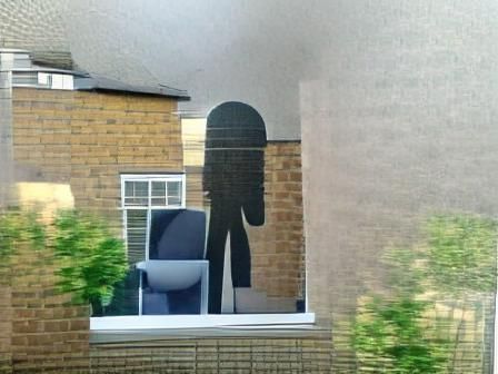 There is a big faceless person outside the window