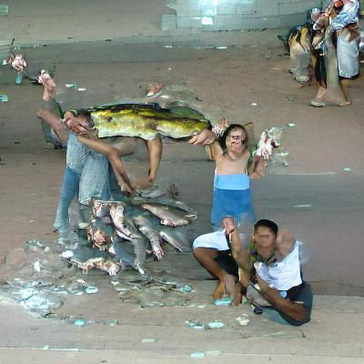 people posing with fish they caught