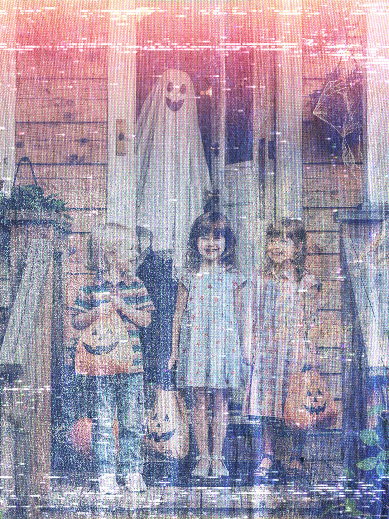 2 little kids on a porch with trick-or-treat bags, a smiling...