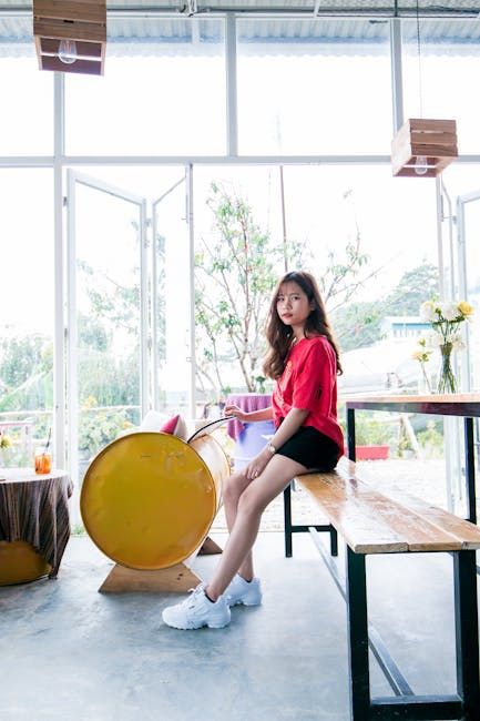 realistics asian girl looks like a flight attendance called tania for use as chatbot persona wearing short sleeves uniform of navy blue