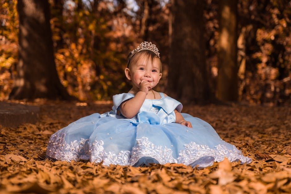 A young royal girl in a beautifully adorned blue royal dress