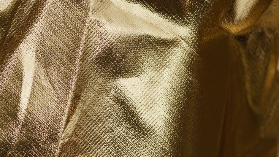 Blonde Kriemhild with very long ringlets hair dressed in middleage fashion,with golden british short hair cat.