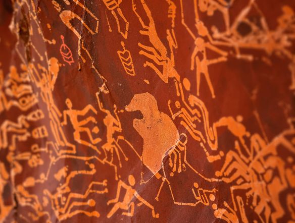 A close-up view of a rock face adorned with vibrant, ancient rock painting style art, depicting a hunting scene with dynamic animal figures and human silhouettes, generated by an Australian rock art generator.