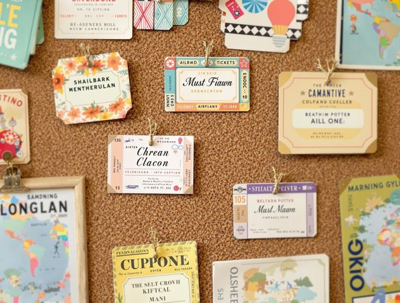 A collection of creative name tags, some resembling miniature airline tickets and boarding passes, displayed on a corkboard filled with travel memorabilia.