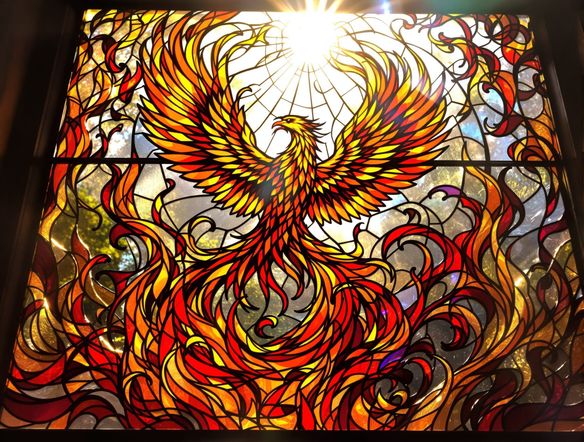 Intricate stained glass window depicting a phoenix rising from flames, vibrant colors, detailed lead lines, light shining through.