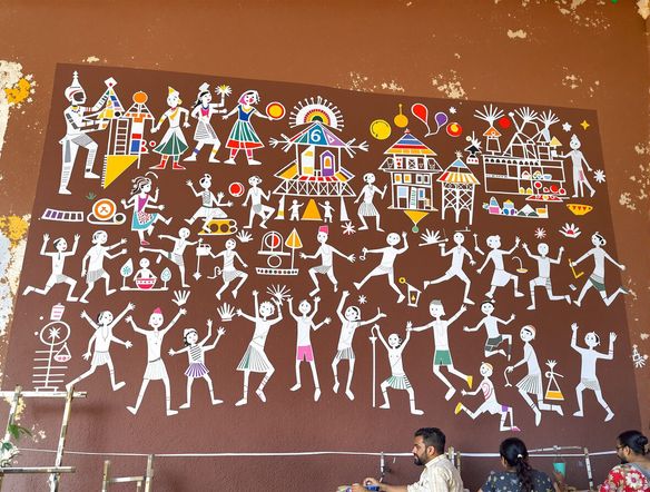 A vibrant Warli folk art mural depicting a village festival, inspired by Hindu mythology. Use geometric shapes and stick figures in white on a rustic brown background. Style: traditional Indian art, AI-generated.