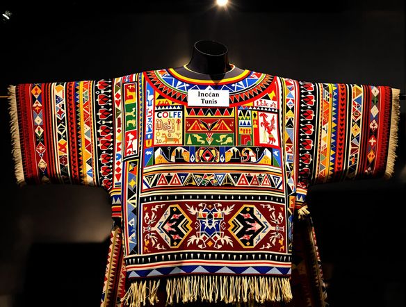 A stylized, colorful Incan tunic displayed as if on a mannequin, featuring intricate geometric and zoomorphic patterns. Peruvian textile pattern generator, ancient Inca clothing art, vibrant colors.