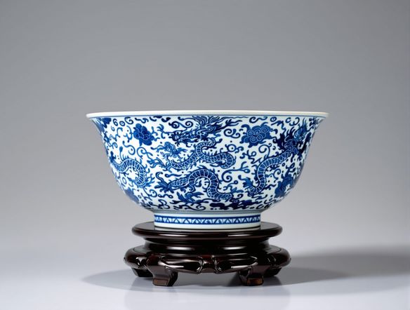 An ornate Ming dynasty blue porcelain bowl, decorated with mythical creatures and cloud motifs, displayed on a wooden stand, in the style of Jingdezhen porcelain art.