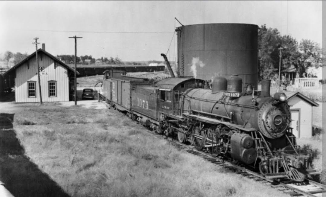 Steam train leaving station.