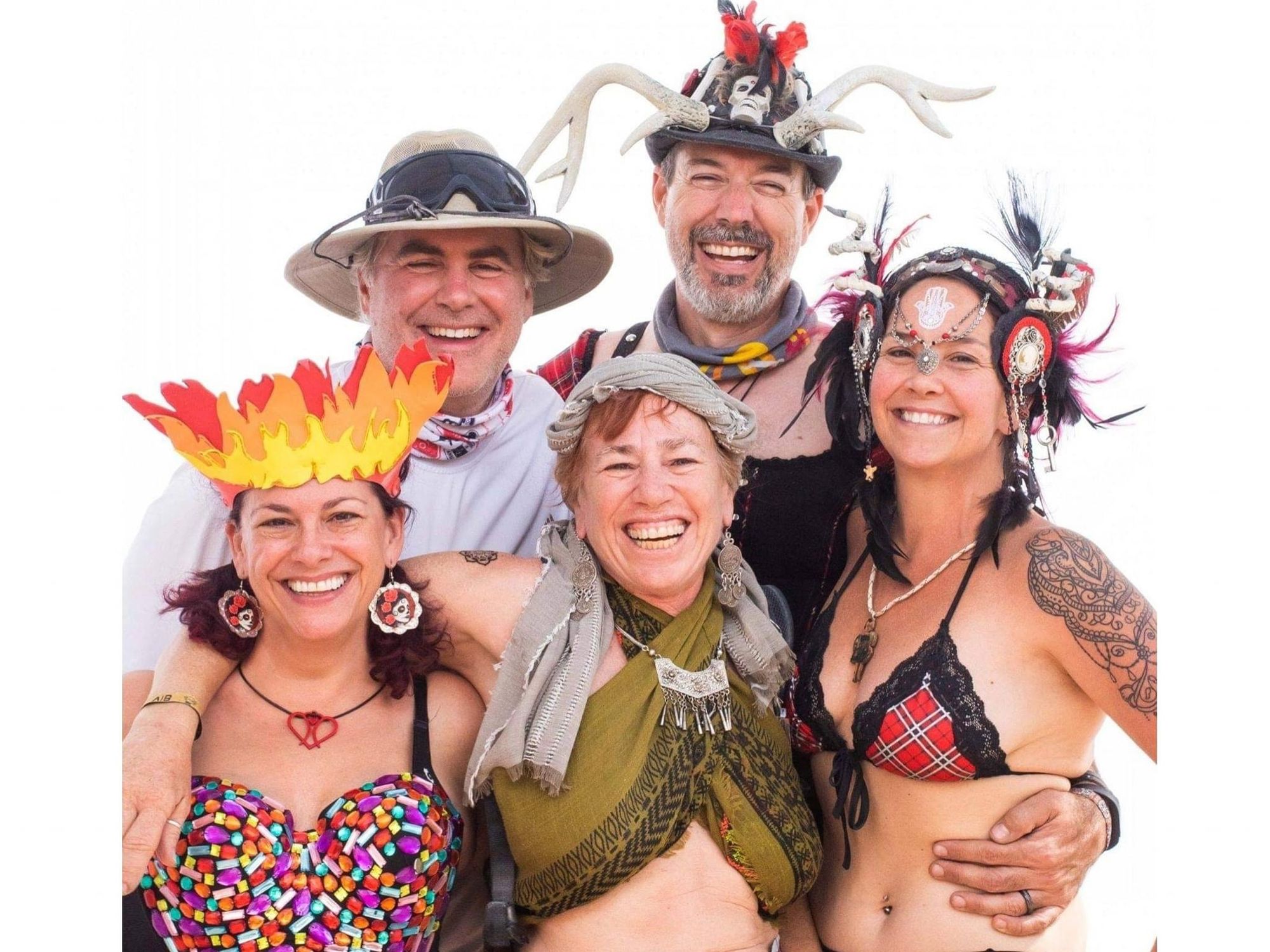 Colorfully costumed people smiling at Burning Man