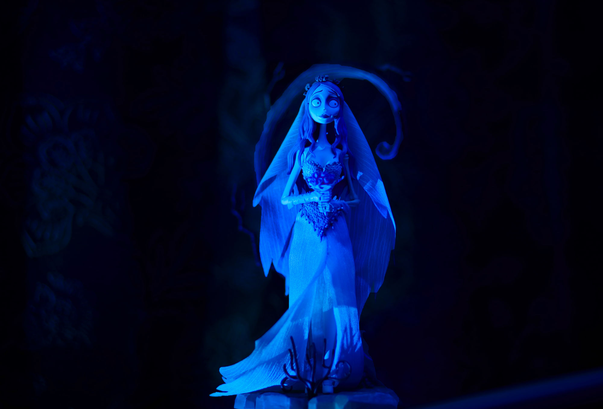 a surreal fantasy with lighting , and dead creepy trees surrounds the model