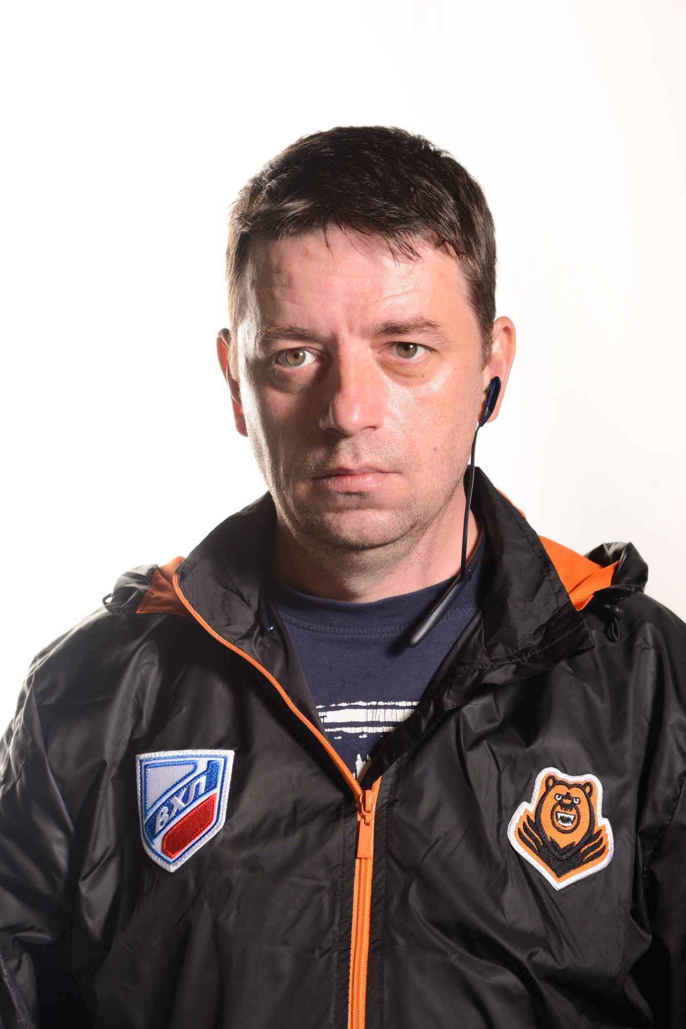 Depict a Bratz-style action man doll made of soft touch plastic. The doll should stand in the recess of the blue box #2F4F8A, as if it were ...