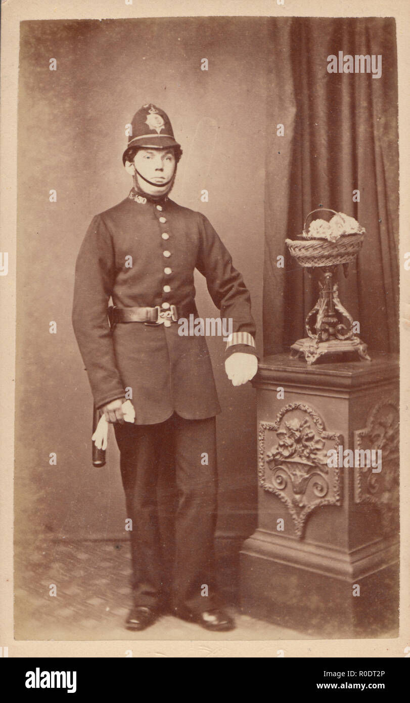 victorian police officer in dark coat with custodian helmet