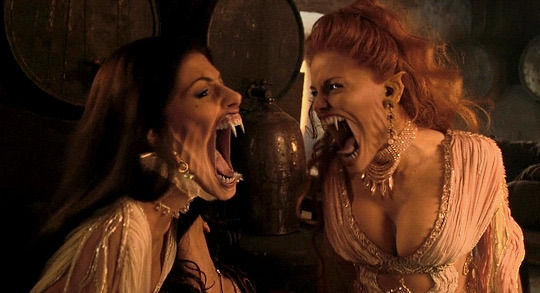 Barbies as vampires hissing with sharp fangs