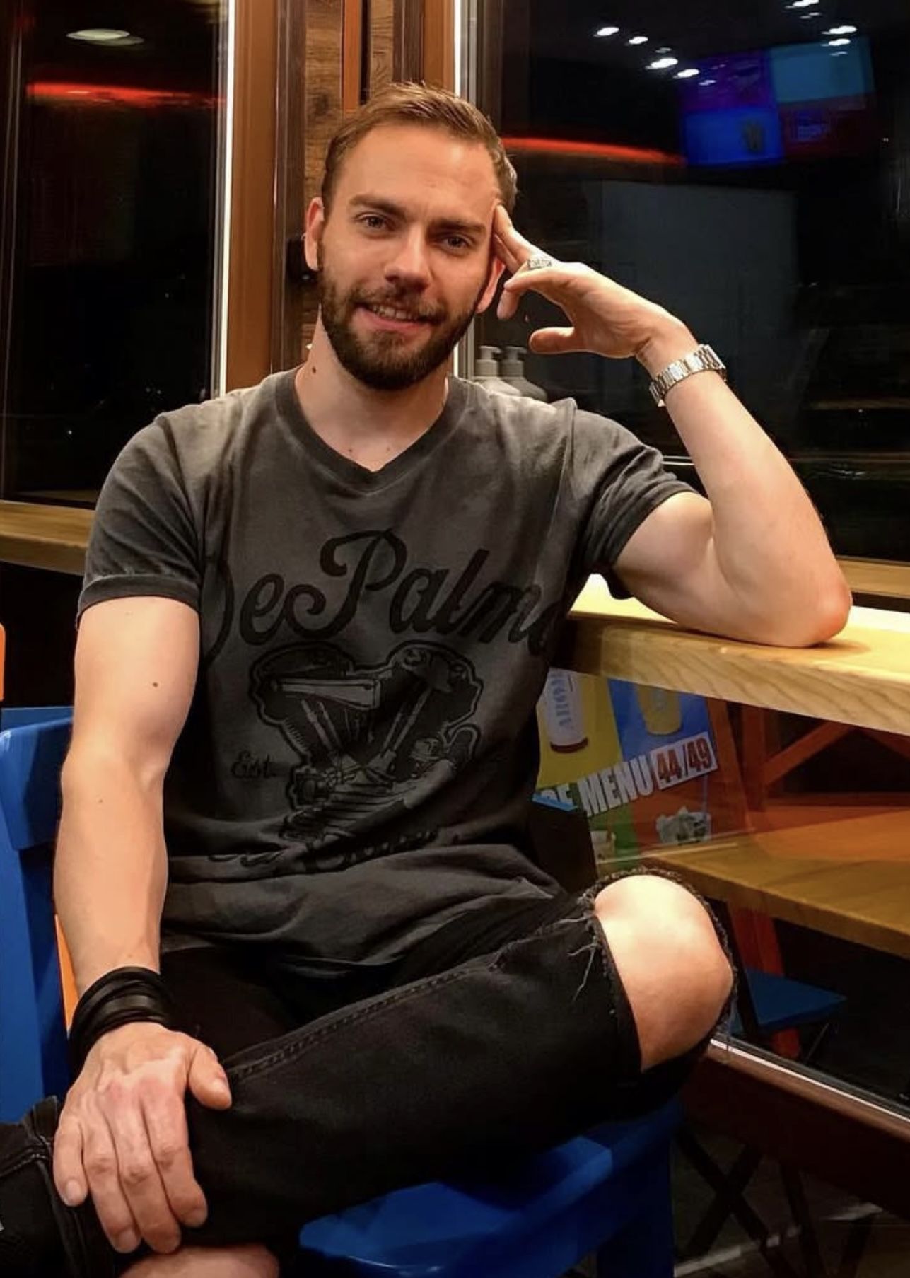 A hyperrealistic portrait of a beautiful man warrior in intricately detailed colorful tactical clothing and futuristic jewellery, standing i...