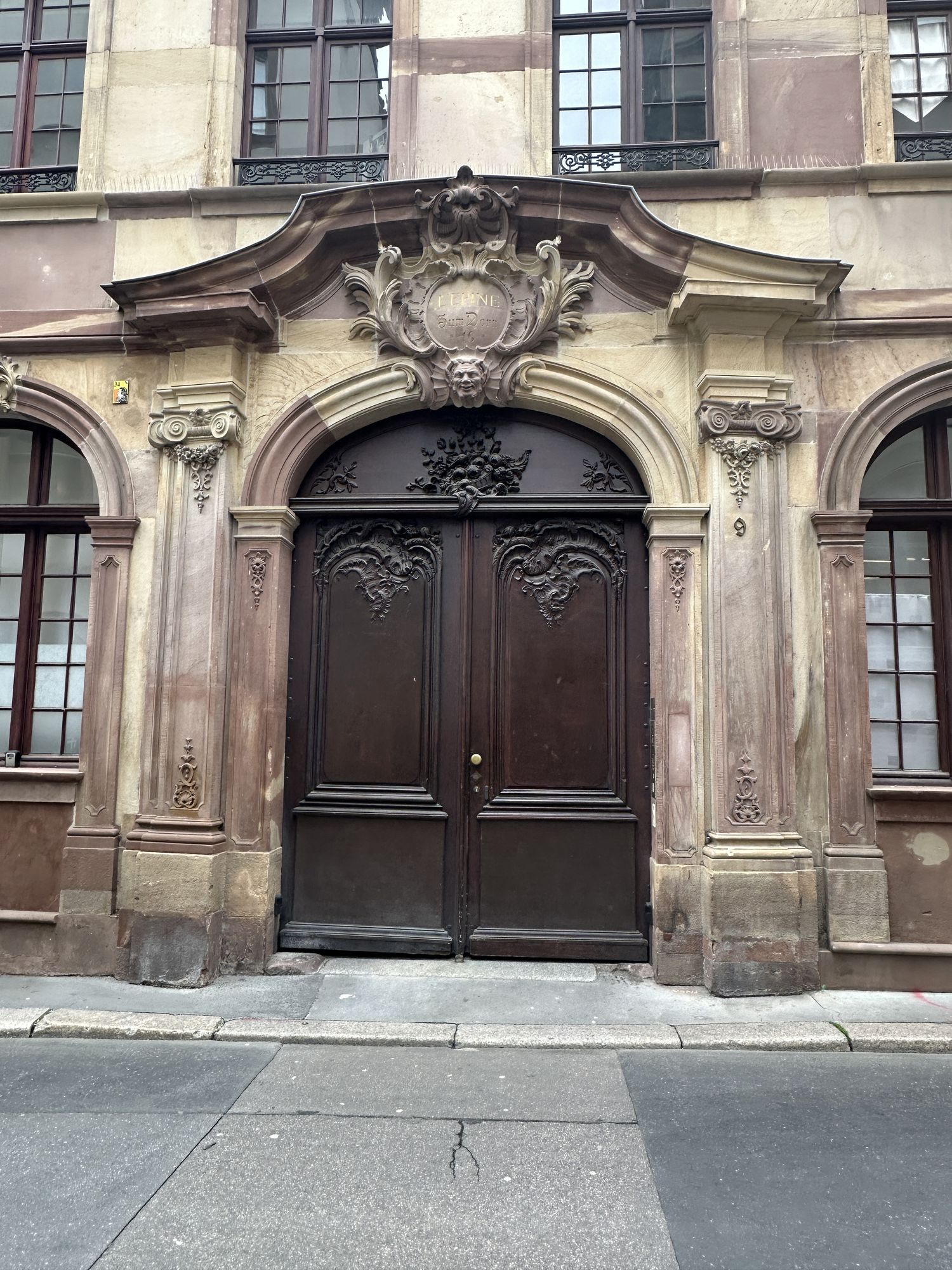 <lora:Romantic Watercolor:1.0> old world city door, textured and chipped stone work along side, a few plants and stone walkway, stray cat si...