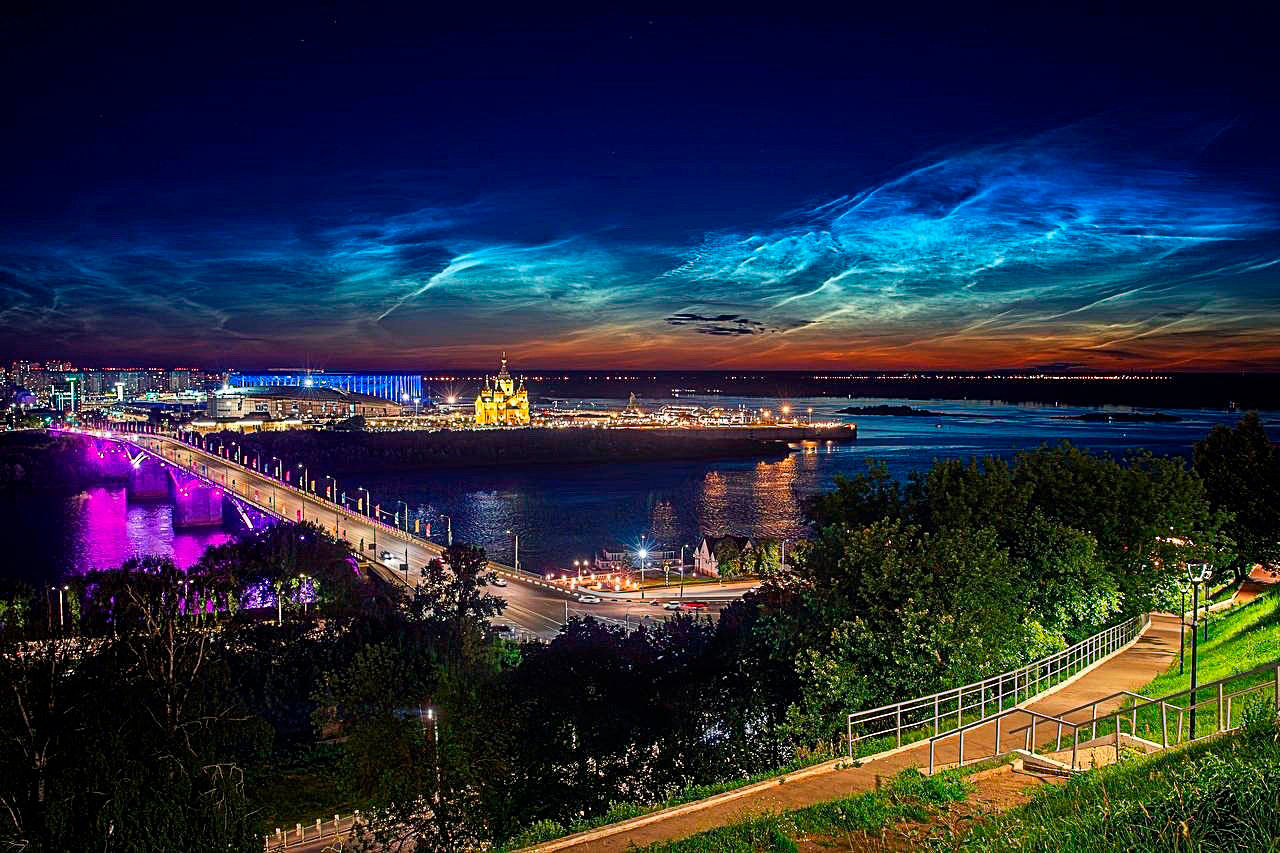 night noctilucent clouds over a seaside town