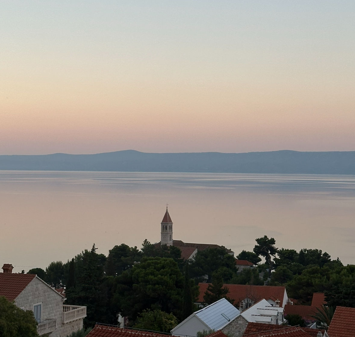<lora:landscape world:1.0> Looking down at Korčula town bell tower Adriatic evening sunset
