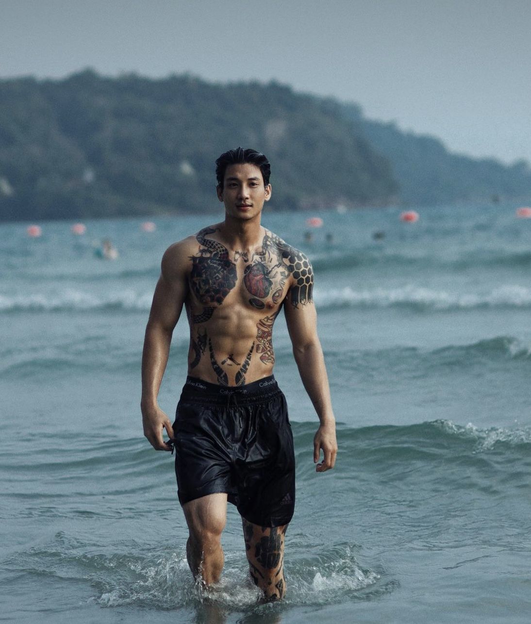 Handsome young Yakuza at the beach