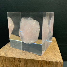 big clear crystal cube, 16th century gold necklace conceal in middle, 20 carat red diamond pendant, metallic control console base, cinematic...