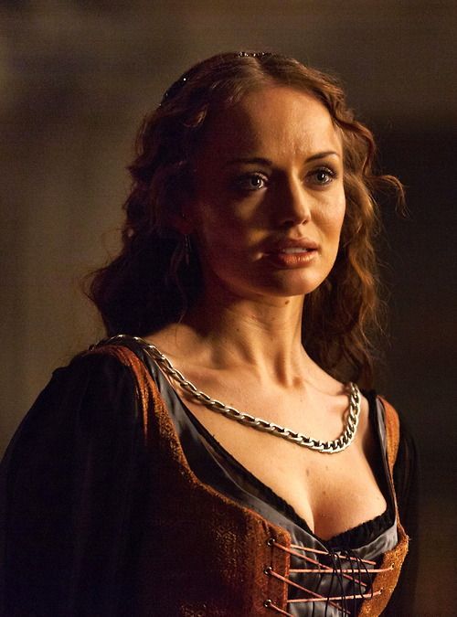 The series house of the dragon. The luxurious throne room where Queen Targaryen is located. She is very beautiful. She has long white hair b...