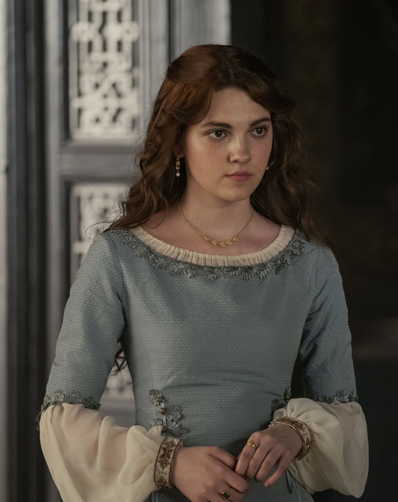 The series house of the dragon. A luxurious medieval hall where everything looks exquisite and expensive. There is a young and beautiful lad...