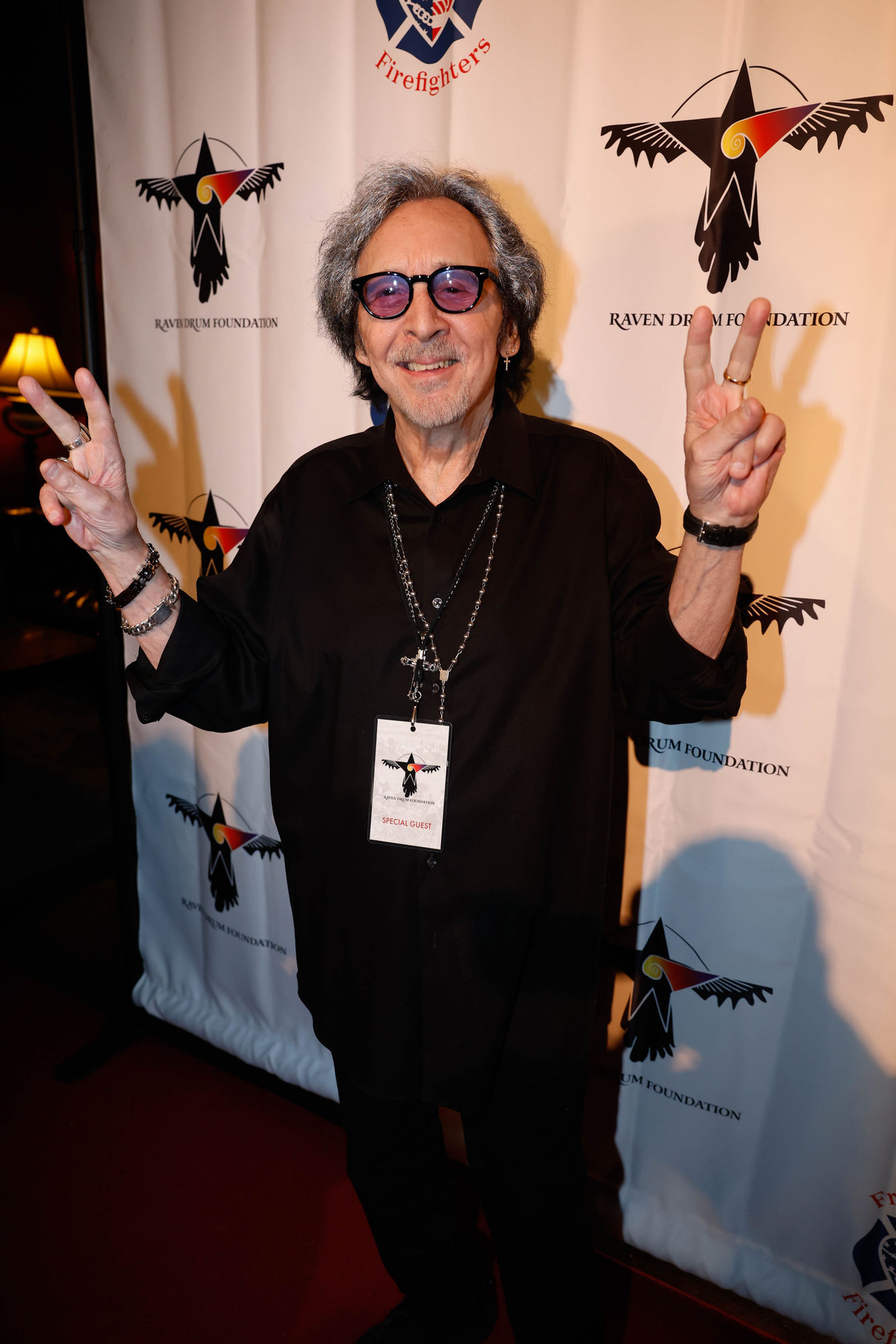 dressed in a robe with a hippie festival in the background