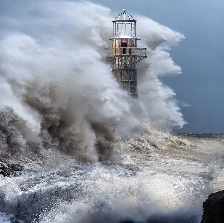 a breathtaking image of a ghostly white lighthouse getting hit by a tsunami with pure black Crows circling the lighthouse