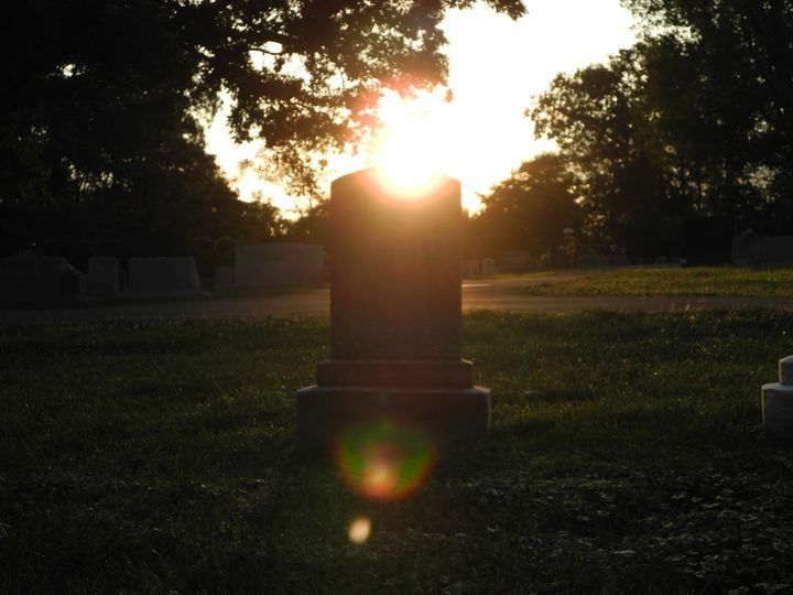 Sun rising over headstone in old cemetery,  oil painting  by Rembrandt 