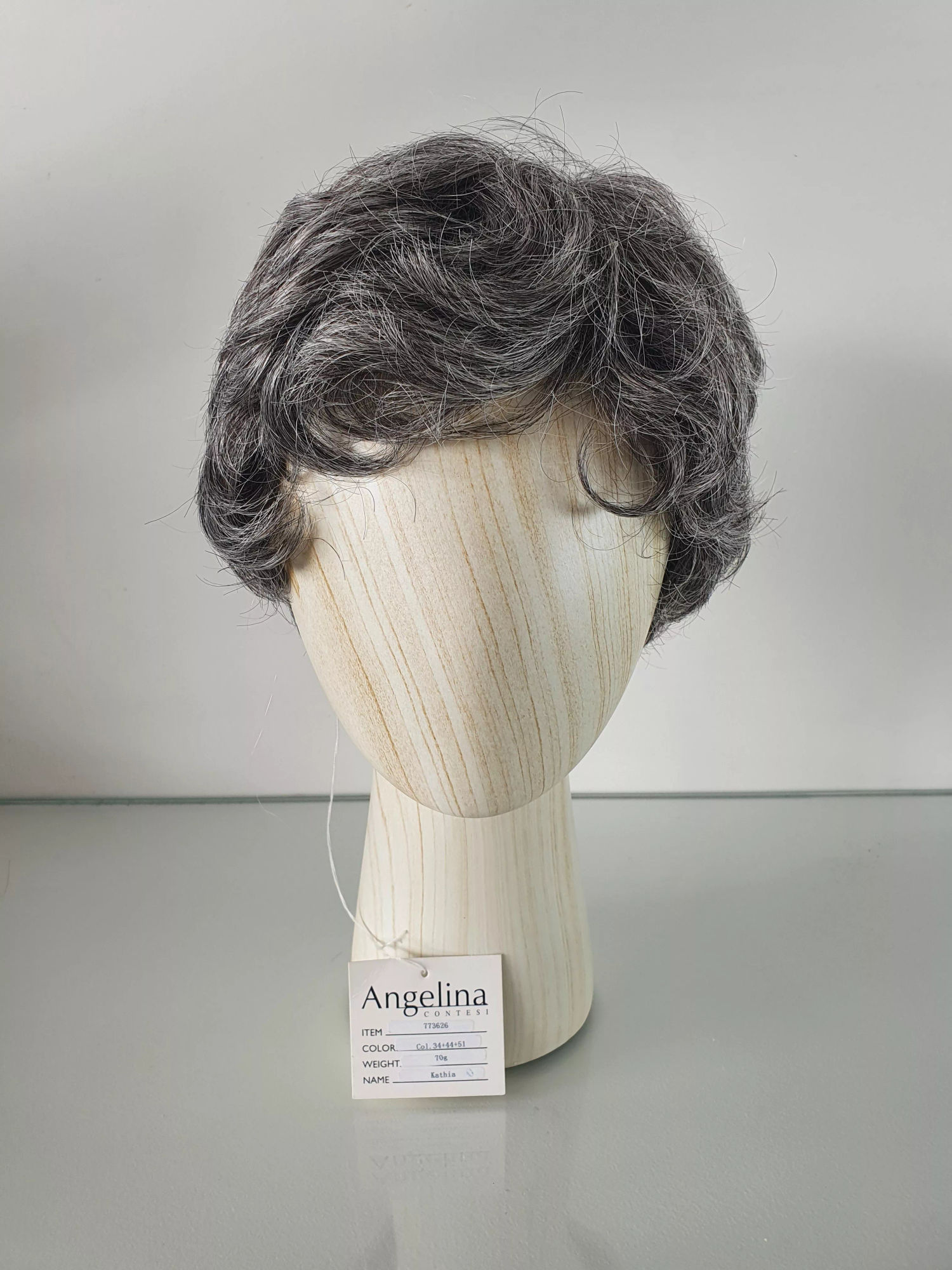 A short gray wig on a display stand in a dark basement. In the style of Mark Brooks and Dan Mumford, with bold lines, dramatic lighting, and...