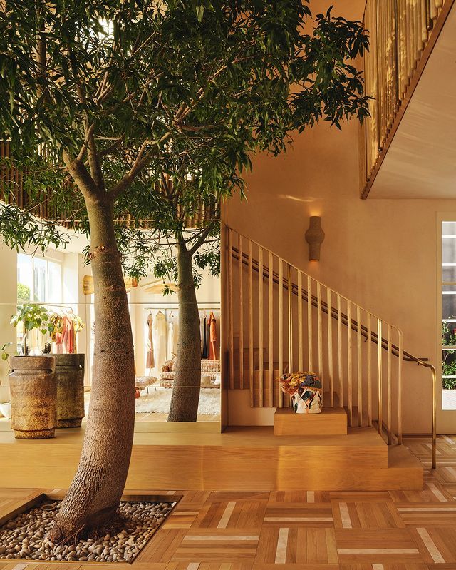 Impressionist painting. Medium shot. Woman stands in a garden. Close-up. Soft pastel colors with sweeping brushstrokes. Gentle sunlight filt...