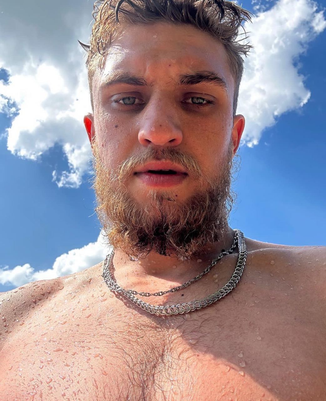 A serious man sits in a black Maserati without a roof and drives around Miami