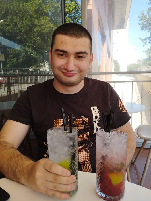 beautiful beach with a nice bar from coconut palms and people at the tables
