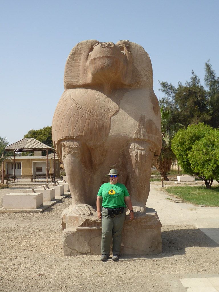 angel of chocolate fudge, an older balding emaciated man with dark batwings flies over the medieval city, with a wave of his scythe a founta...