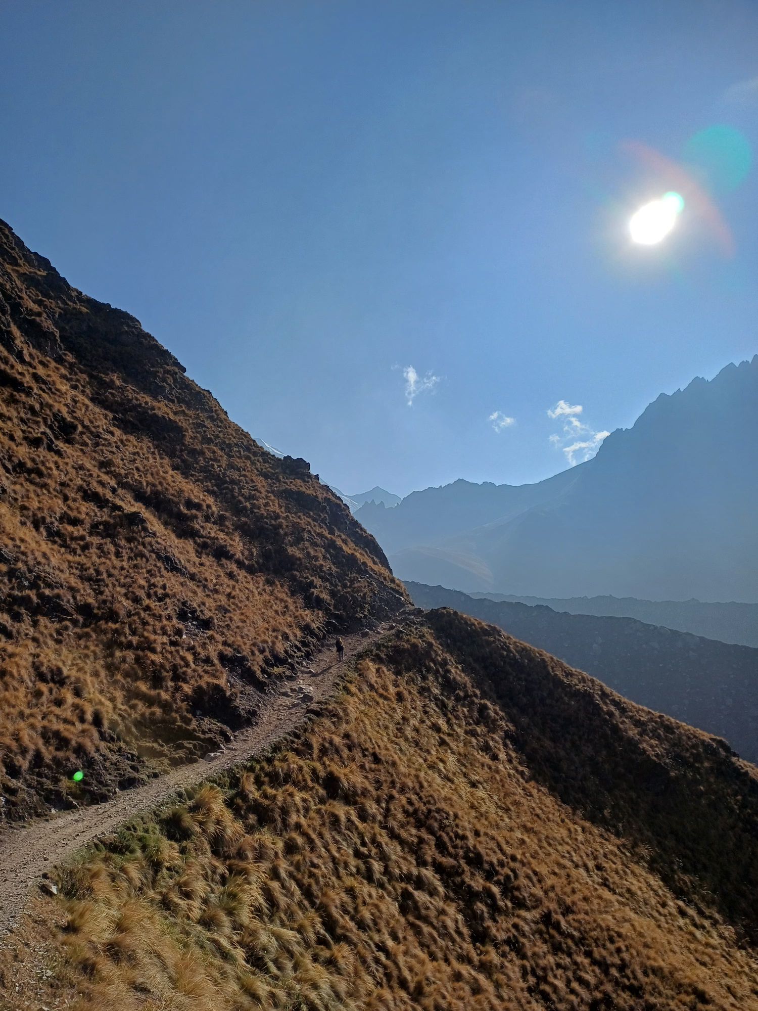 With a sunset mood and colours, with a mystical, very beautiful young woman on the path who looks like The mountain goddess