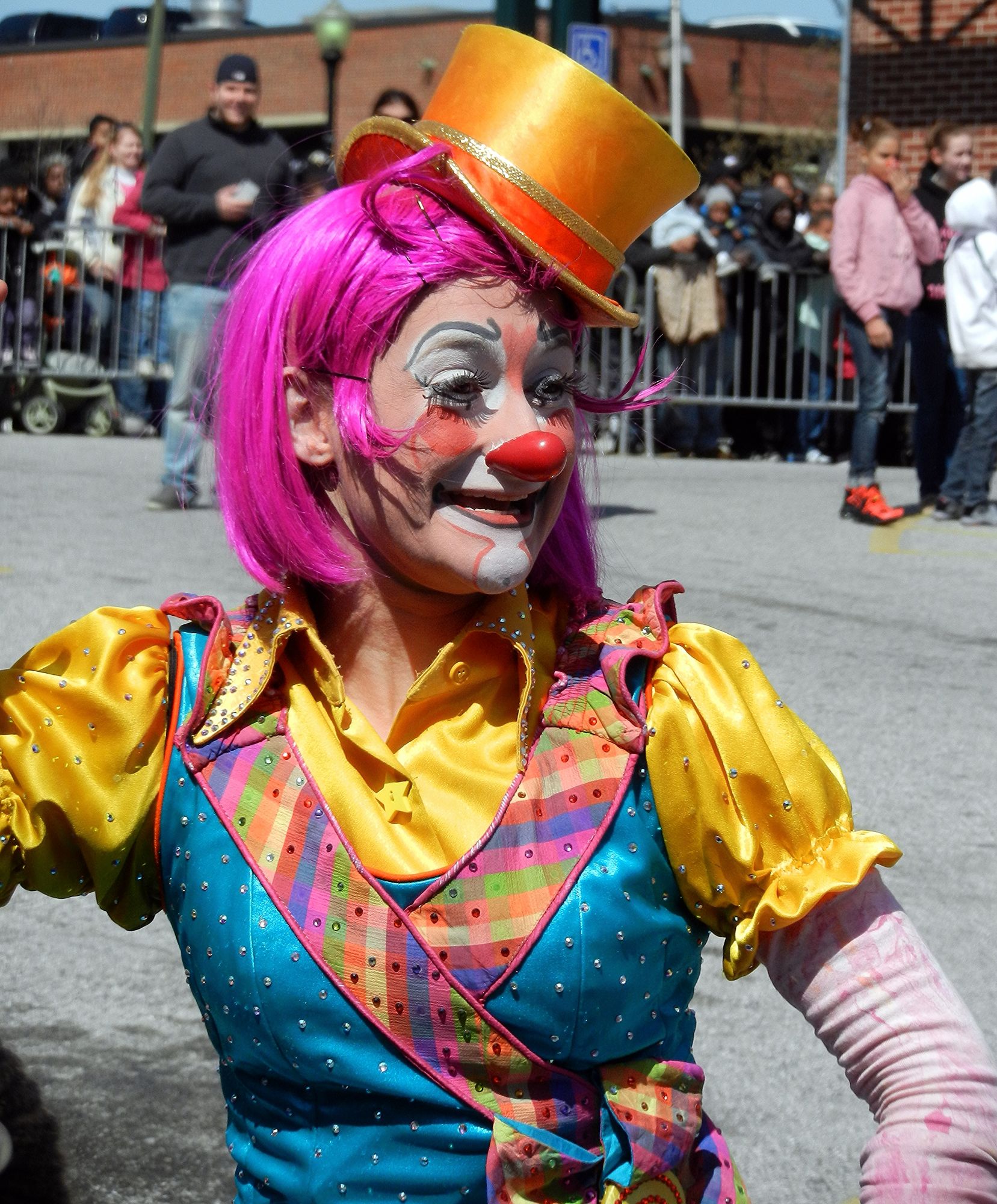 A smiling female circus clown with a circus tent in the background steampunk engine