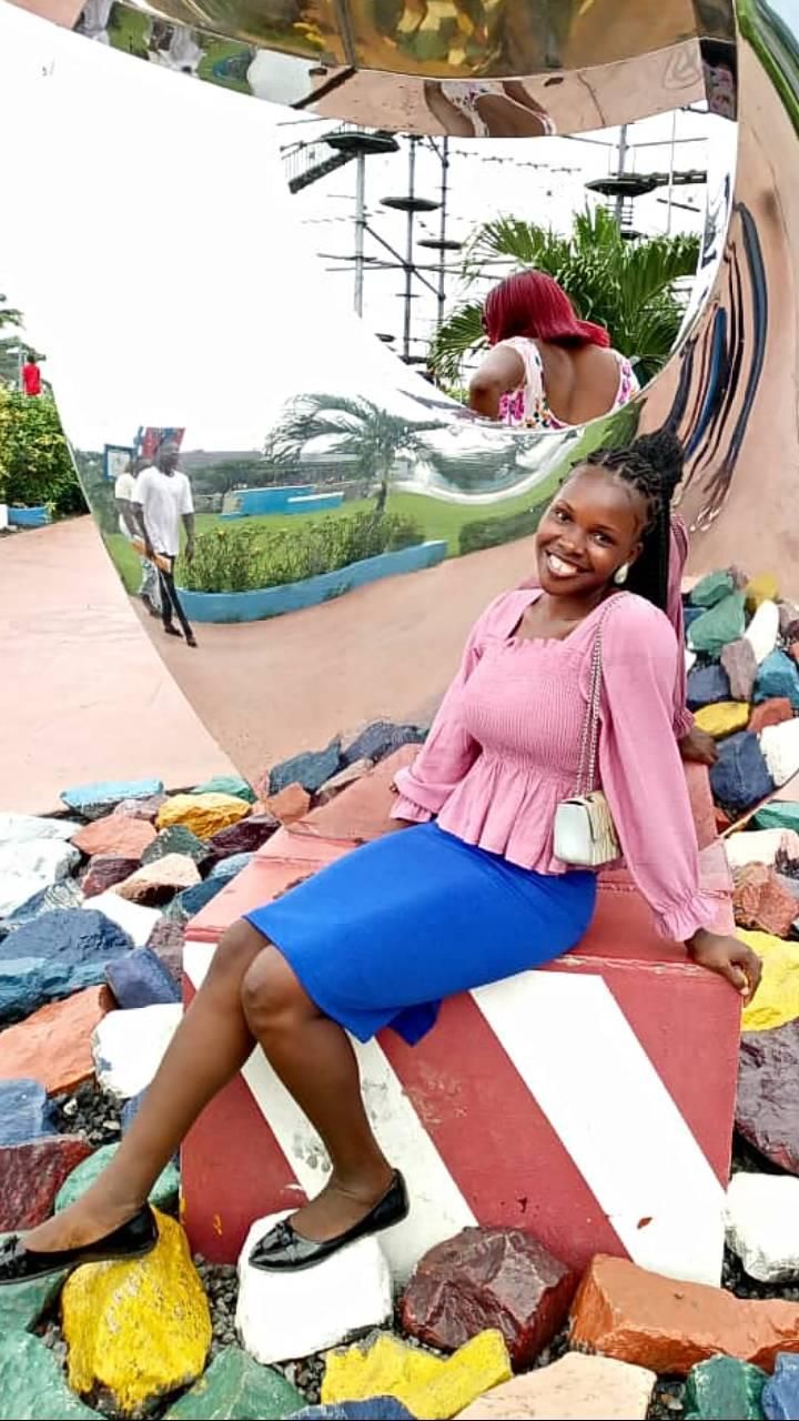 A beautiful young lady sitting and smiling 