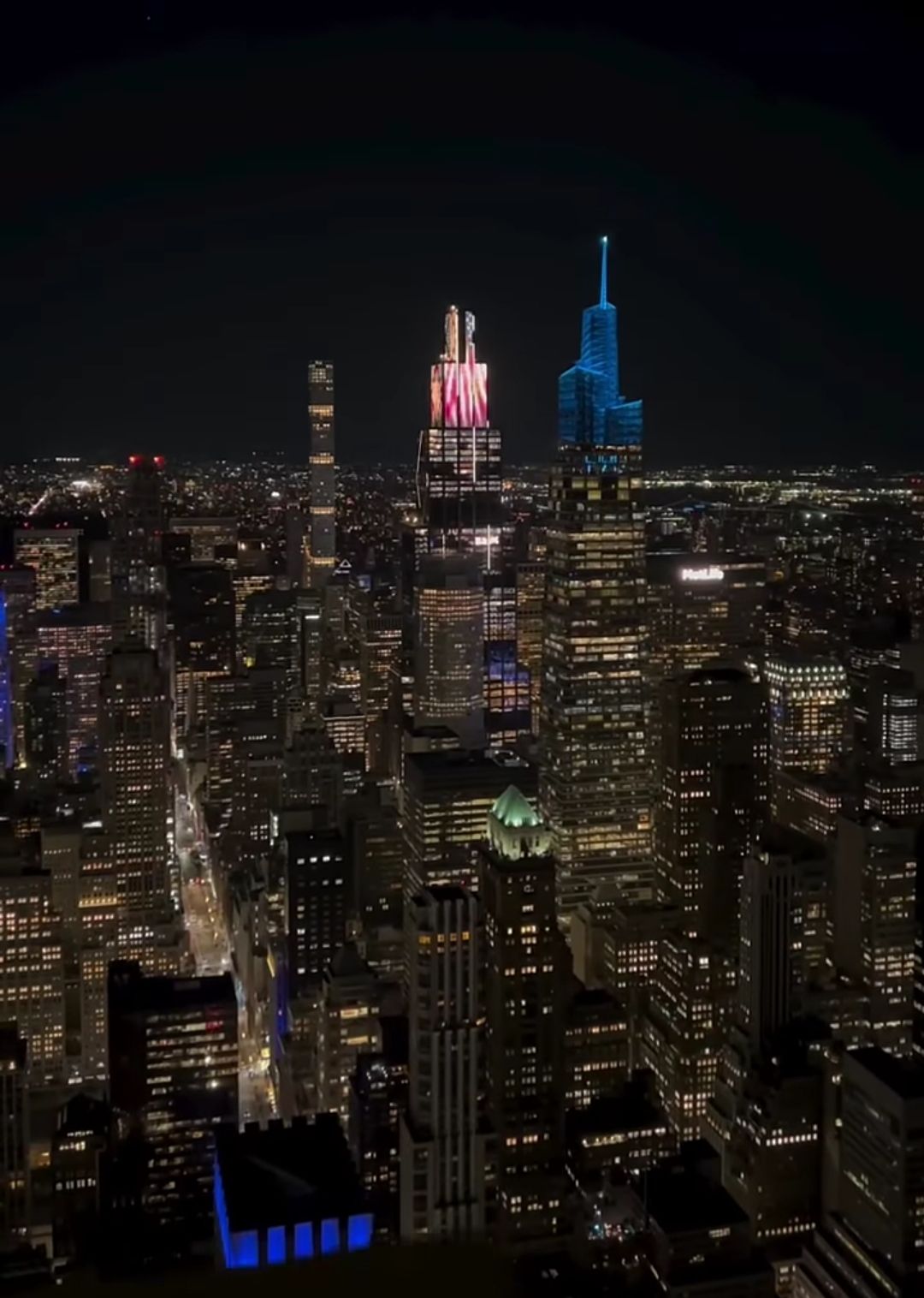  A bustling cyberpunk metropolis at night with towering skyscrapers adorned with holographic advertisements and flying vehicles with neon li...