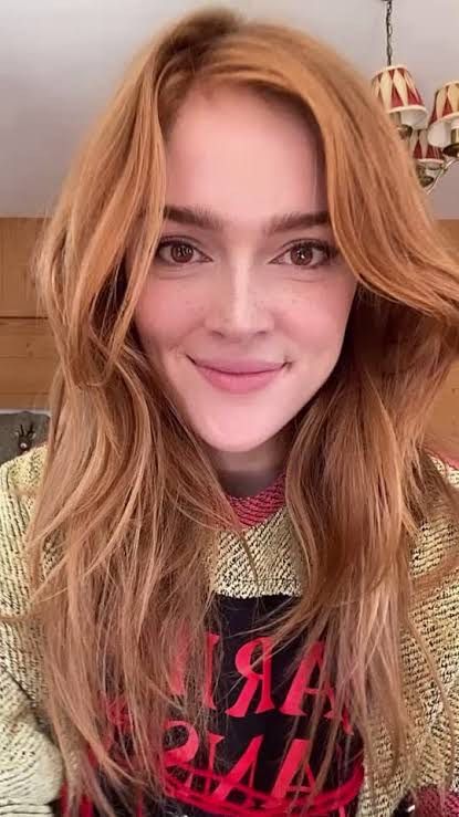 A gorgeous 30-something redhead depicting Rati-The Hindu Goddess of Love-sitting beside and having her head stuck completely inside the open...