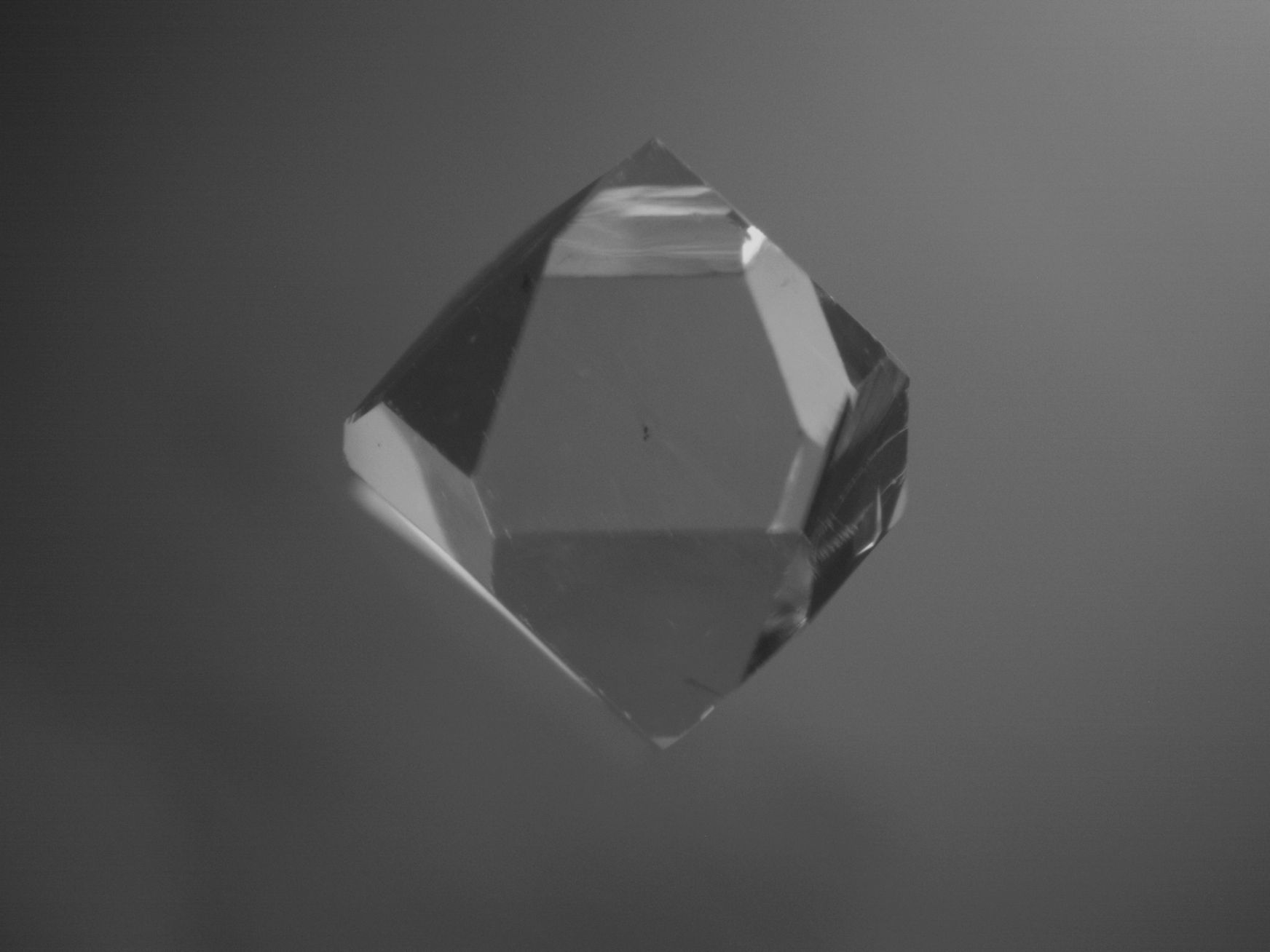 A beautiful sparkling gem hovering in the sky with a bright white neon glow