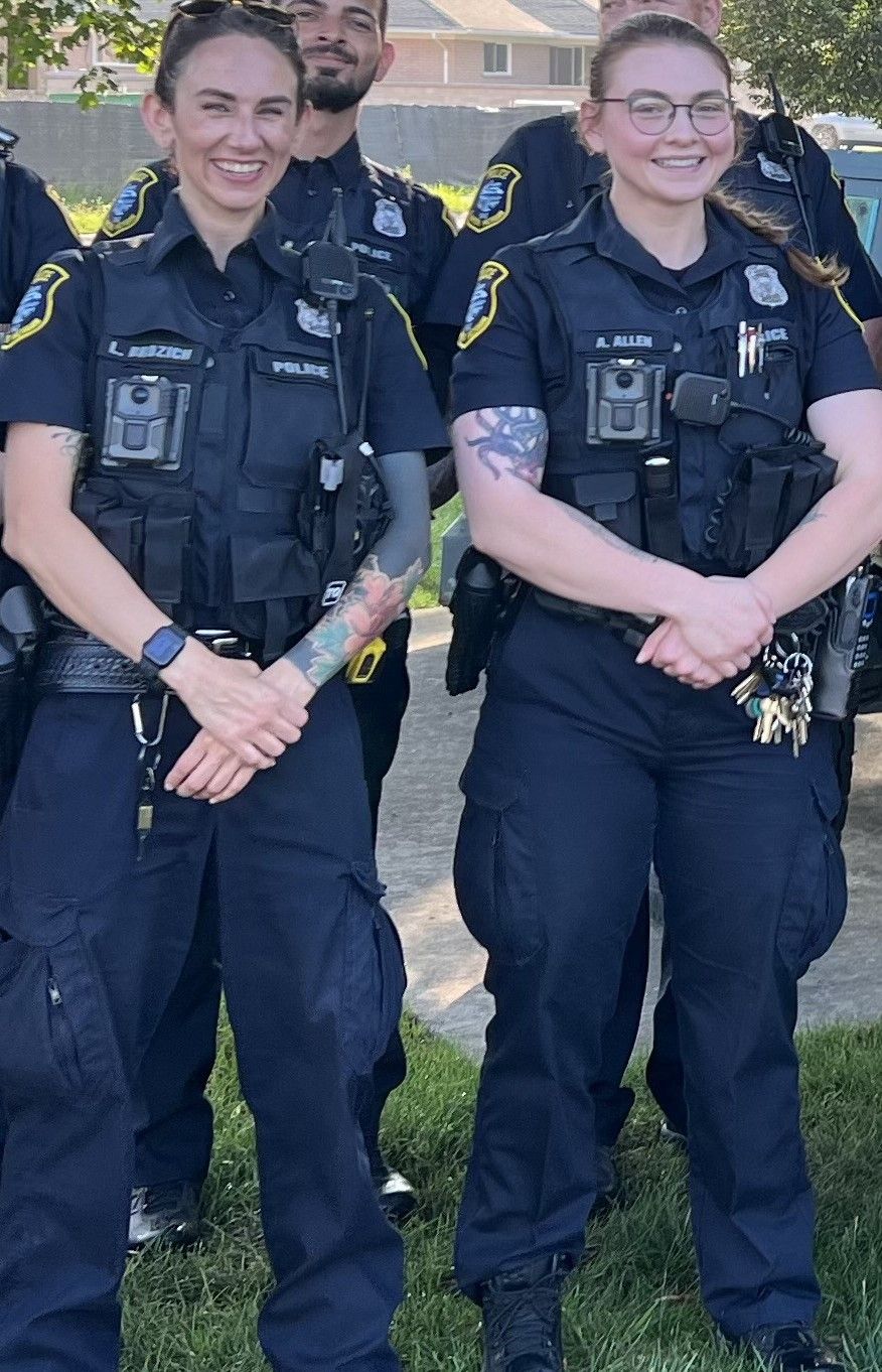 Fat blonde batgirl and curvy ginger female Robin in eyemasks and utility belts with capes from the batman & Robin movie in a well-lit Batcav...