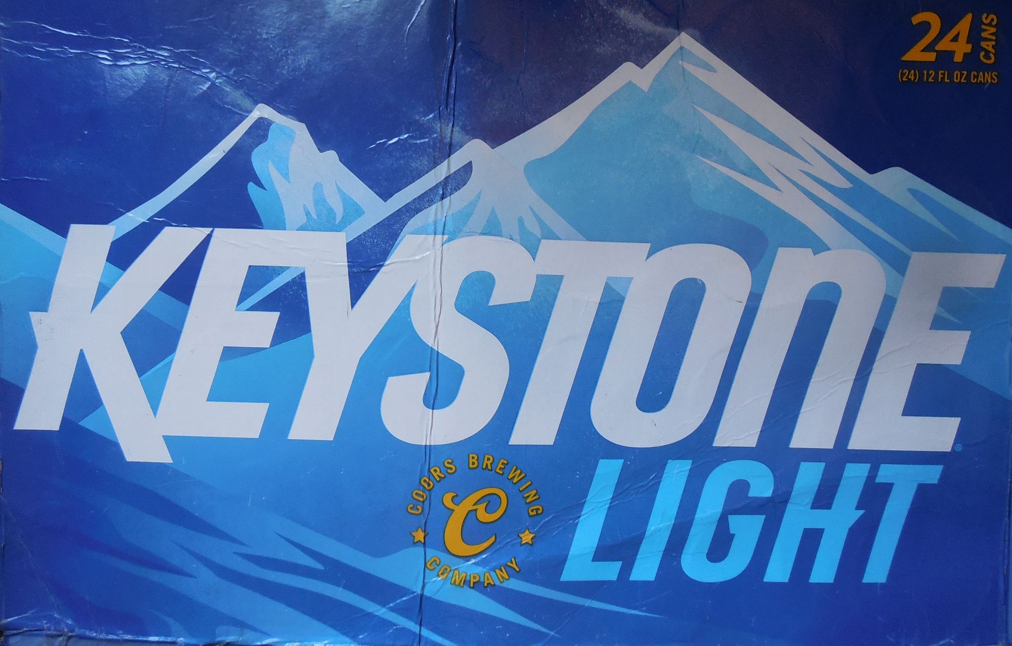 Keystone Light. Beer. Coors Brewing Company. Snow Covered Mountains. Bright Blue Sky. Snow. Intense White Sunlight.