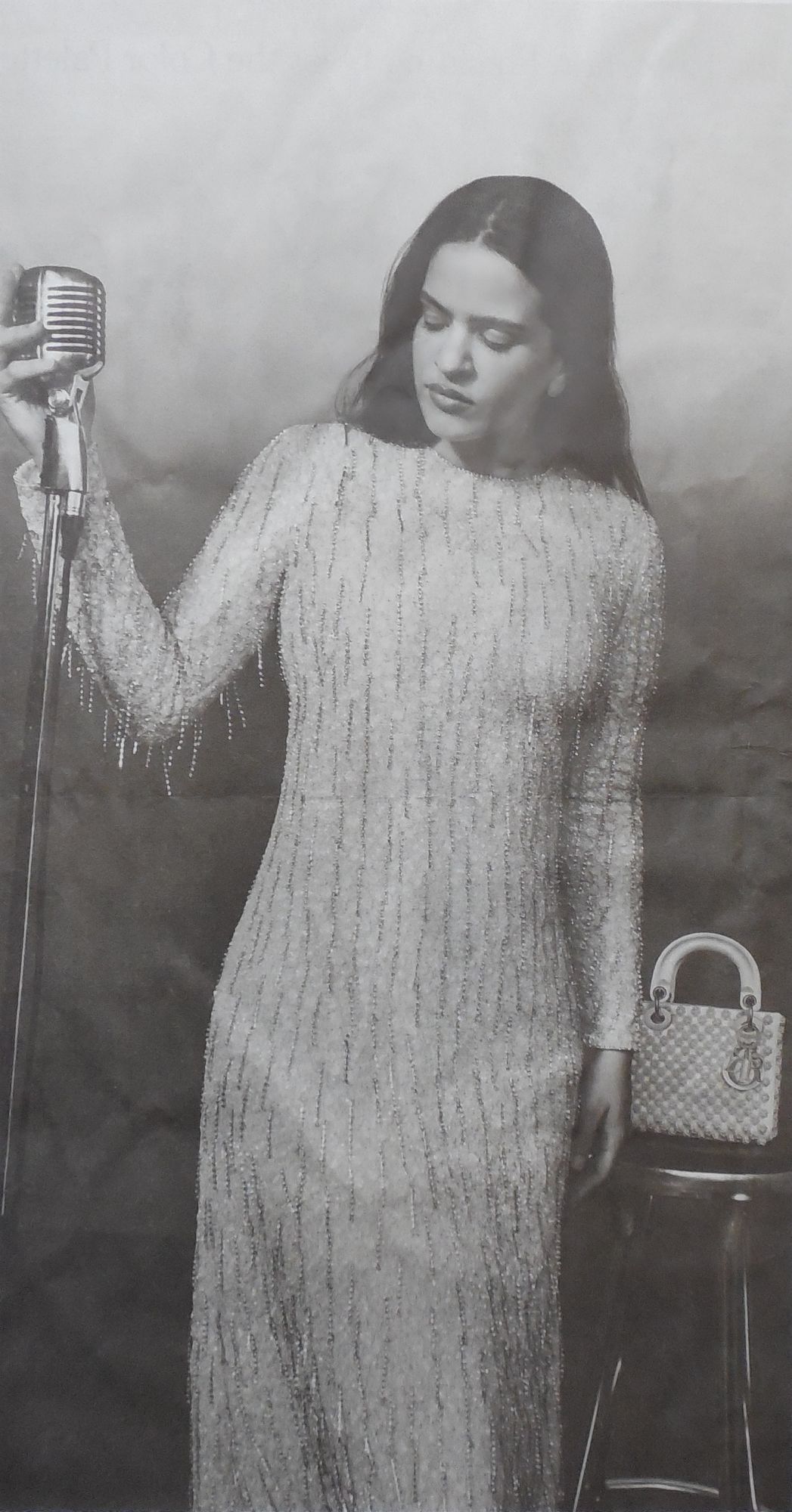 1940's singer, super model. dior. white dress. singer. microphone. old fashioned music.
