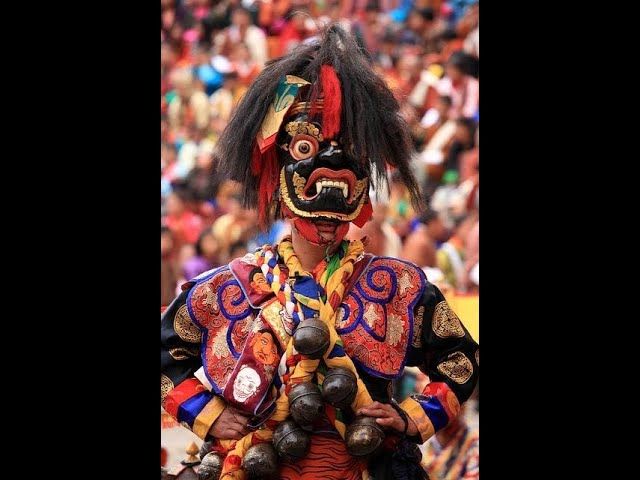 a Bhutanese monk in front of the reference picture