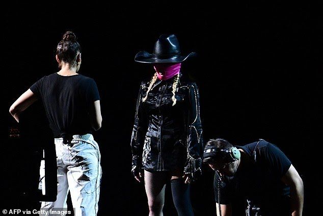 Madonna photoshoot wearing pink balaclava and big cowboy hat realistic Cinematic film still, shot on v-raptor XL, film grain, vignette, colo...