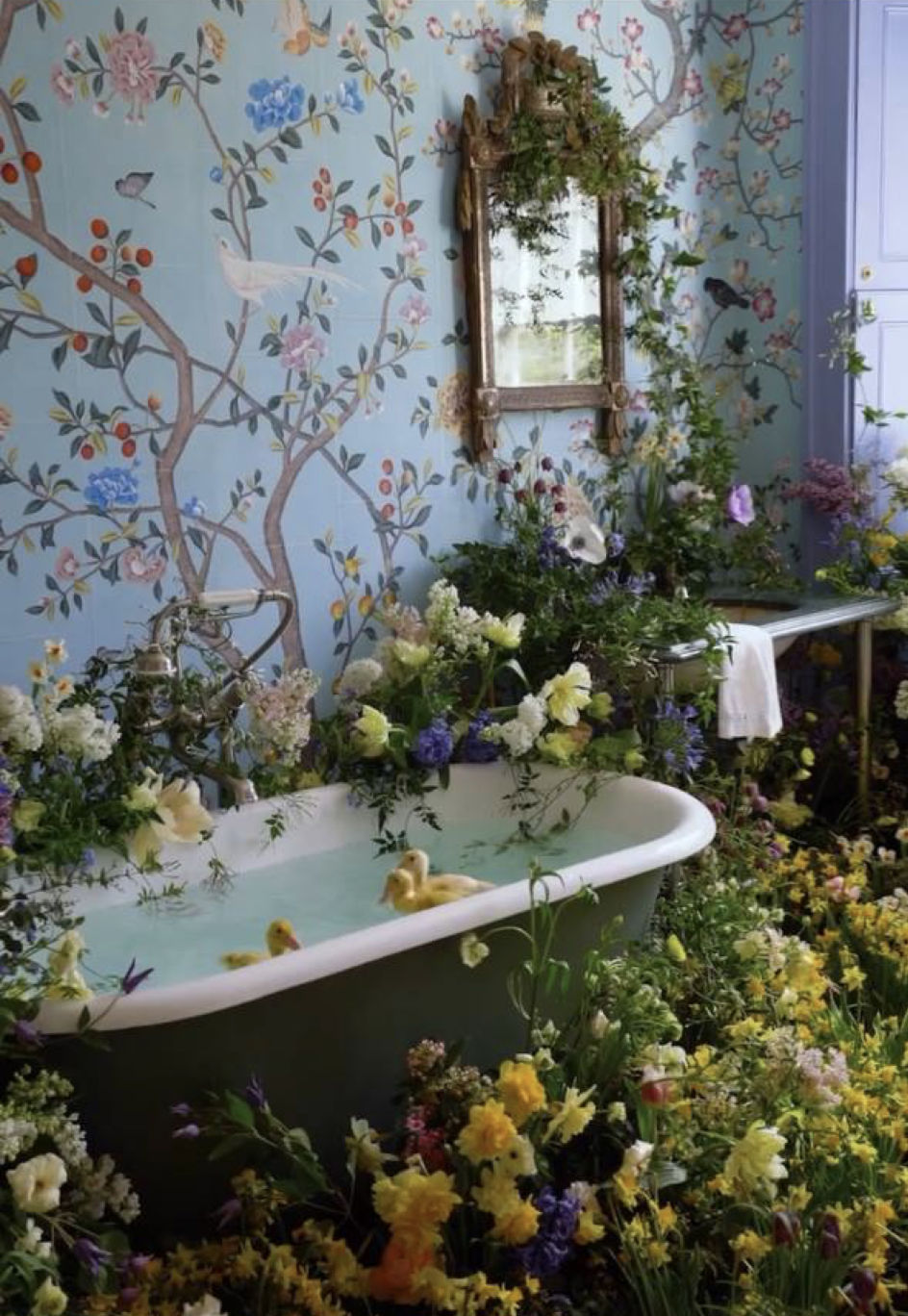 18 century room with light blue Chinoiserie on walls, big elegant mirrors in golden carved framing, many yellow and blue flowers, white clas...