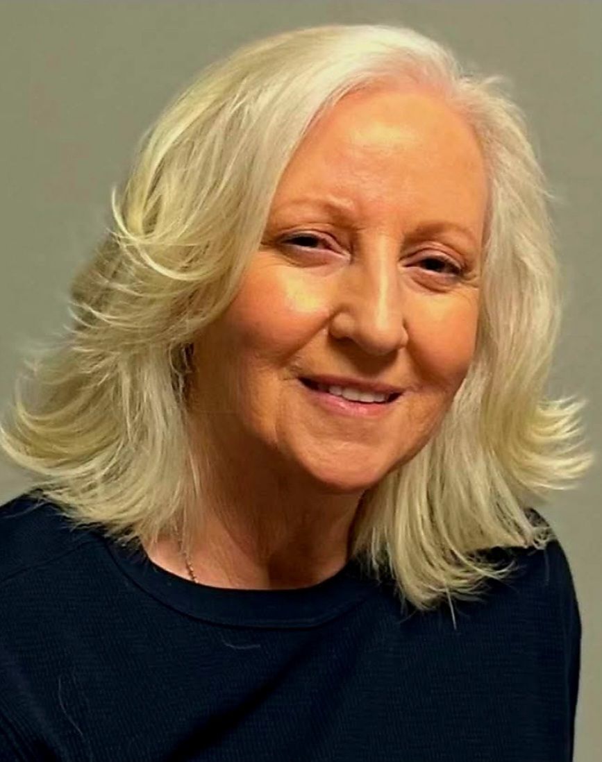 Make her a model, dressed for a rock concert, ridding on the back of the Harley, 