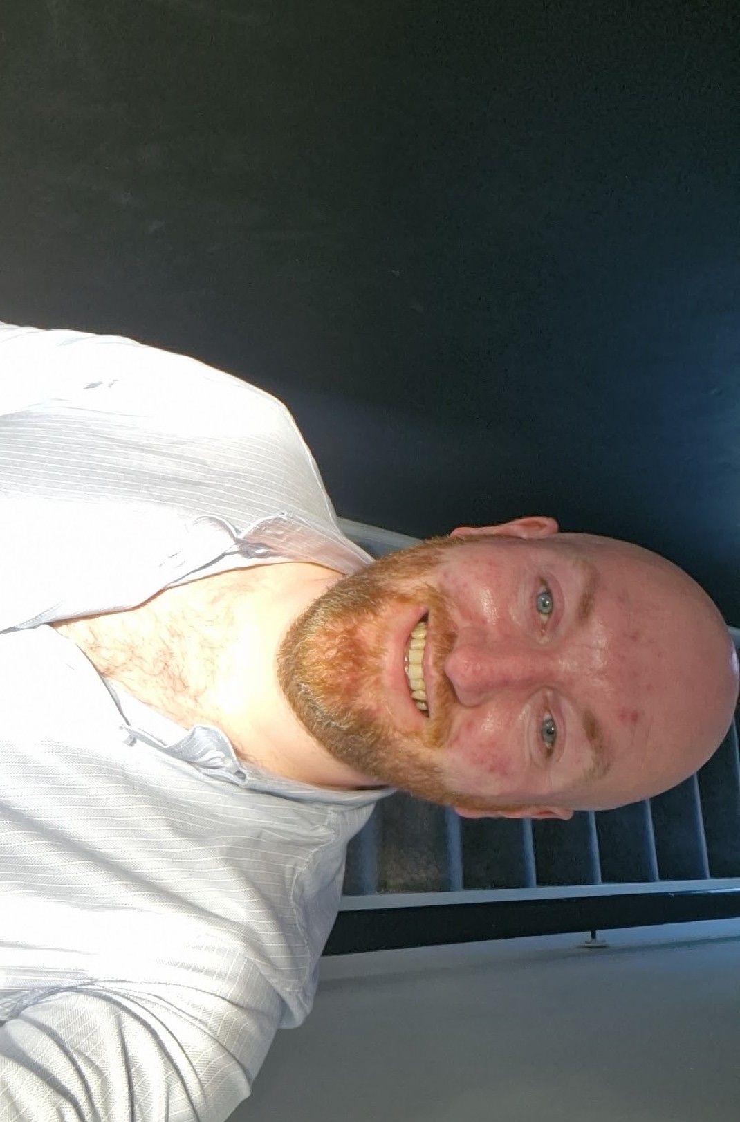 a wrestler who has just won the match with his opponent defeated in the corner. the referee holding his hand in the air as the winner with t...